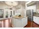 Modern kitchen featuring a large island, stainless steel appliances, and granite countertops at 6321 Spotted Fawn Run, Littleton, CO 80125
