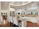 Spacious open kitchen with white cabinetry, stainless steel appliances, and large island with breakfast bar at 6321 Spotted Fawn Run, Littleton, CO 80125