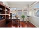 Cozy office featuring hardwood floors, a built-in bookcase, and bright natural light at 6321 Spotted Fawn Run, Littleton, CO 80125