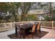 Inviting outdoor patio with a dining table, rug, and charming string lights at 6321 Spotted Fawn Run, Littleton, CO 80125
