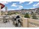 Outdoor patio featuring a grill, dining set, and beautiful mountain views at 6321 Spotted Fawn Run, Littleton, CO 80125