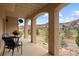 Covered patio with mountain views. Features a table and chairs at 6321 Spotted Fawn Run, Littleton, CO 80125