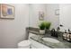 Stylish powder room with green granite countertop, sleek fixtures, and contemporary decor at 6321 Spotted Fawn Run, Littleton, CO 80125