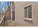 A balcony featuring a tan brick wall and sliding glass door at 1149 Columbine St # 202, Denver, CO 80206