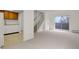 Open-concept living area with neutral tones, staircase, and access to a balcony for natural light at 1149 Columbine St # 202, Denver, CO 80206