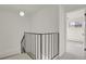View from staircase landing, showing black railing and an open doorway at 1149 Columbine St # 202, Denver, CO 80206