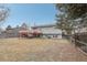 Back exterior view of house with deck and fenced yard at 1204 Balmora St, Lafayette, CO 80026