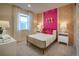 Stylish bedroom featuring fun patterned wallpaper, a metal frame bed, and bright pillows at 23751 E 40Th Ave, Aurora, CO 80019