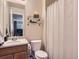 Neutral-colored bathroom features a white shower curtain and open shelving at 10534 Westcliff Pl, Highlands Ranch, CO 80130