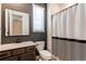 Stylish bathroom featuring a single sink vanity, toilet, and shower with decorative curtain at 24197 E Ada Ave, Aurora, CO 80018