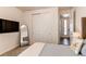 Cozy bedroom features a large closet with sliding doors, a full length mirror, and television at 24197 E Ada Ave, Aurora, CO 80018