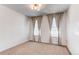 Bright bedroom featuring neutral carpet, two large windows with stylish curtains, and ample space at 24197 E Ada Ave, Aurora, CO 80018
