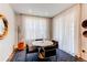 Bright dining area with stylish chairs, circular table, large window, and dramatic floor-to-ceiling curtains at 24197 E Ada Ave, Aurora, CO 80018