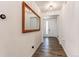 Entryway features wood floors, a digital thermostat, decorative mirror and a view of the front door at 24197 E Ada Ave, Aurora, CO 80018
