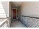 Entryway featuring stone accents, a stained wood front door, and ample natural light at 24197 E Ada Ave, Aurora, CO 80018