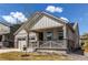 Inviting single-Gathering home featuring a covered porch and partial lawn view at 24197 E Ada Ave, Aurora, CO 80018