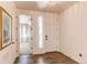Bright foyer boasting hardwood floors, white walls, and adjacent living space at 24197 E Ada Ave, Aurora, CO 80018