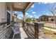 Cozy front porch featuring stone accents, white chairs, and neighborhood views at 24197 E Ada Ave, Aurora, CO 80018