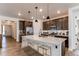 Spacious kitchen features a large island with seating, modern lighting, and stainless steel appliances at 24197 E Ada Ave, Aurora, CO 80018