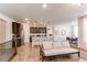 Open concept kitchen and living room featuring an eat-in island, bar stools, and stainless steel appliances at 24197 E Ada Ave, Aurora, CO 80018