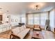 Open concept living room with modern décor, dining area, and stylish furniture at 24197 E Ada Ave, Aurora, CO 80018