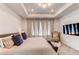 Spacious main bedroom with a large bed, tray ceiling, and ample natural light from multiple windows at 24197 E Ada Ave, Aurora, CO 80018