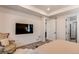 Spacious main bedroom with a TV, sitting chair, and an ensuite bathroom with bright natural light at 24197 E Ada Ave, Aurora, CO 80018
