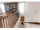 Staircase with dark wood and black railings descends near an open living area at 24197 E Ada Ave, Aurora, CO 80018