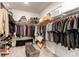 Spacious walk-in closet with ample hanging space, shelving, and a comfortable bench for dressing at 24197 E Ada Ave, Aurora, CO 80018