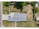 A bird's-eye view of the home showing its large backyard, long driveway, and proximity to trees at 6924 S Albion St, Centennial, CO 80122