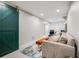 Finished basement with comfortable sofa, wooden bench, and decorative sliding door at 6924 S Albion St, Centennial, CO 80122