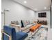 Finished basement with comfortable seating area and a decorative area rug at 6924 S Albion St, Centennial, CO 80122