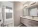 Light and bright bathroom featuring double sinks, stylish vanity, and tiled shower at 6924 S Albion St, Centennial, CO 80122