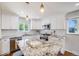 Modern kitchen with white cabinets, granite countertops, stainless appliances, and a convenient center island at 6924 S Albion St, Centennial, CO 80122