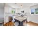 Bright kitchen featuring white cabinets, stainless steel appliances, and granite countertops on the center island at 6924 S Albion St, Centennial, CO 80122