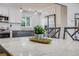 Bright eat-in kitchen featuring modern appliances, gray countertops, white cabinetry and stylish pendant lighting at 6924 S Albion St, Centennial, CO 80122