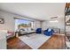 Bright living room features hardwood floors, large windows, and stylish decor for a comfortable space at 6924 S Albion St, Centennial, CO 80122