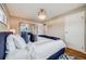 Spacious main bedroom with large window, generous light and a statement chandelier at 6924 S Albion St, Centennial, CO 80122