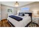 Relaxing main bedroom offers natural light, a decorative chandelier, and beautiful hardwood floors at 6924 S Albion St, Centennial, CO 80122