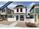 Charming two-story home featuring a covered porch, white siding, and tasteful architectural details at 10346 Uvalda Ave, Commerce City, CO 80022