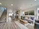 Modern living room featuring comfortable seating, stylish decor, and an open staircase at 10346 Uvalda Ave, Commerce City, CO 80022