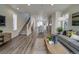Spacious living area with an open layout, modern decor, and seamless flow to the kitchen at 10346 Uvalda Ave, Commerce City, CO 80022