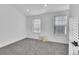 Well-lit bedroom with gray carpeting and two windows at 10537 W Maplewood # B, Littleton, CO 80127