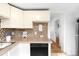 Kitchen featuring white cabinets, light countertops, and stainless steel appliances at 4030 W 49Th Ave, Denver, CO 80212