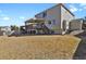 The back exterior of this home reveals large lawn, back deck, and light gray color at 5521 S Yakima St, Aurora, CO 80015
