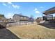 Spacious backyard with brown lawn and wood fence, perfect for outdoor activities and entertaining at 5521 S Yakima St, Aurora, CO 80015