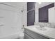 Modern bathroom featuring white tile, vanity with granite countertop, and shower/tub combo at 5521 S Yakima St, Aurora, CO 80015