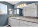 Bathroom featuring double vanity with granite counters, mosaic backsplash, stylish lighting, and large mirror at 5521 S Yakima St, Aurora, CO 80015