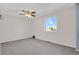Well-lit bedroom featuring a neutral color palette, ceiling fan, and a large window at 5521 S Yakima St, Aurora, CO 80015