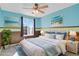 Bedroom with blue accents, featuring wall art and a window view at 5521 S Yakima St, Aurora, CO 80015